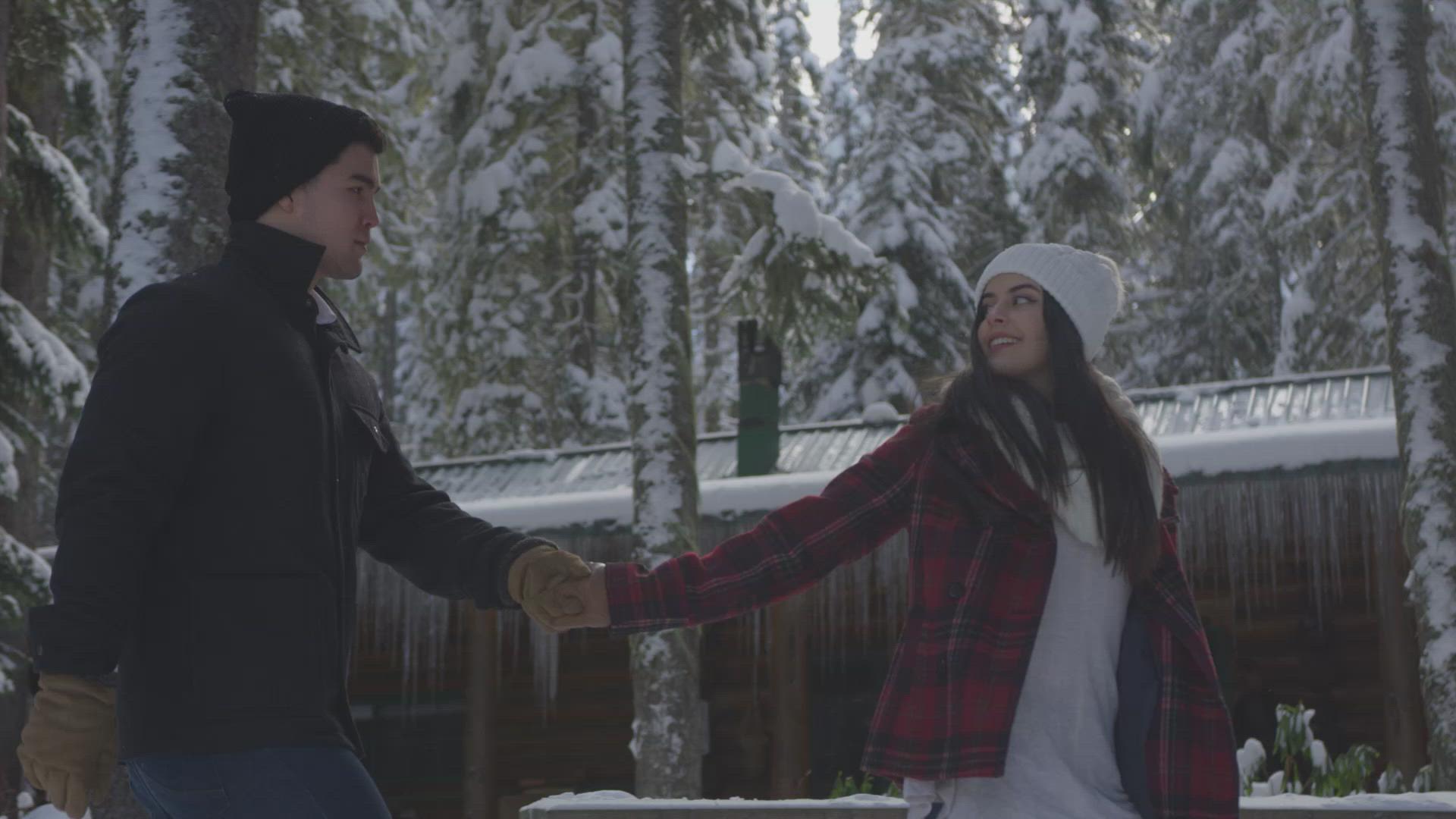 Couple Walking Past Cabin in Snow – FILMPAC