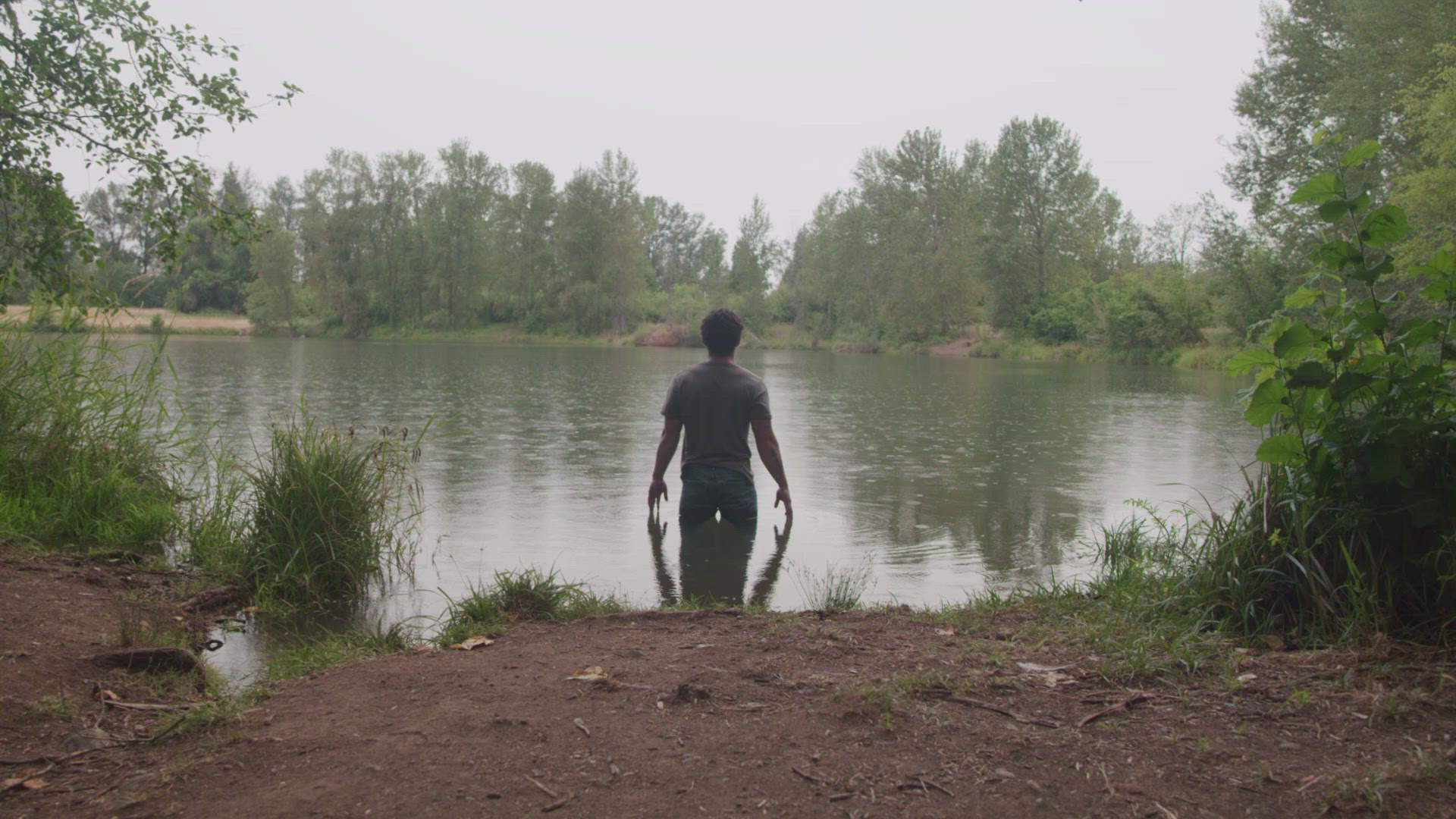 emotional-guy-standing-in-a-dreary-lake-filmpac